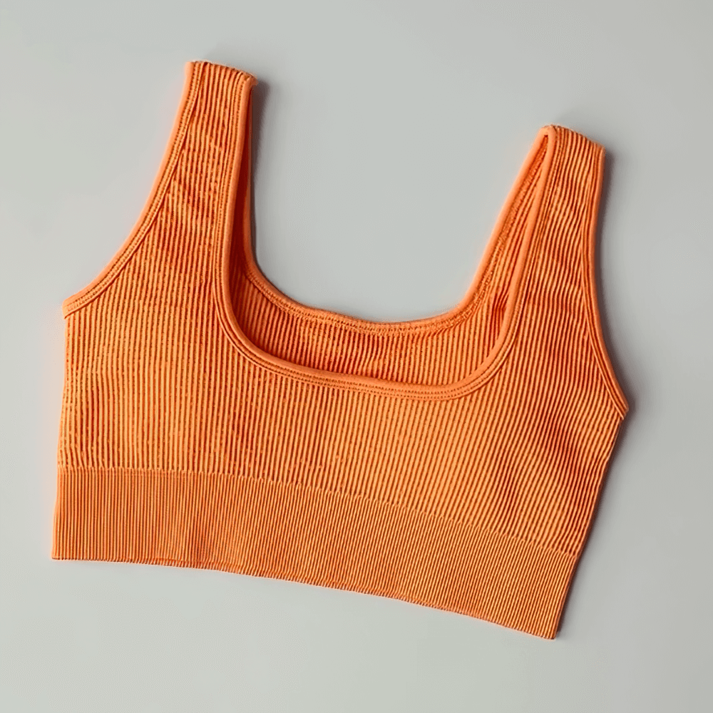 Orange seamless ribbed sports bra SF2186 with removable cups, supportive nylon-spandex blend for yoga and fitness activities.